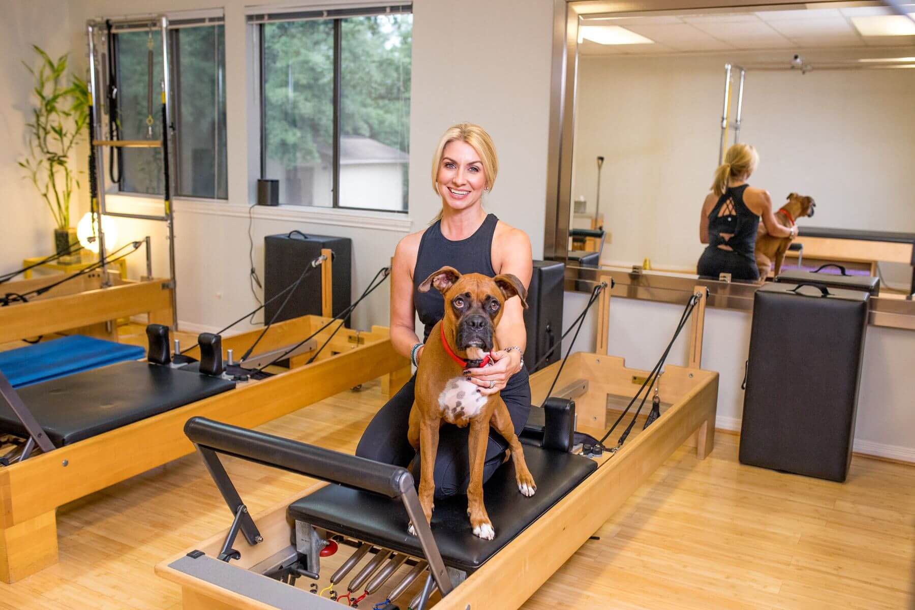 Cheryl and her dog on the Pilates Reformer